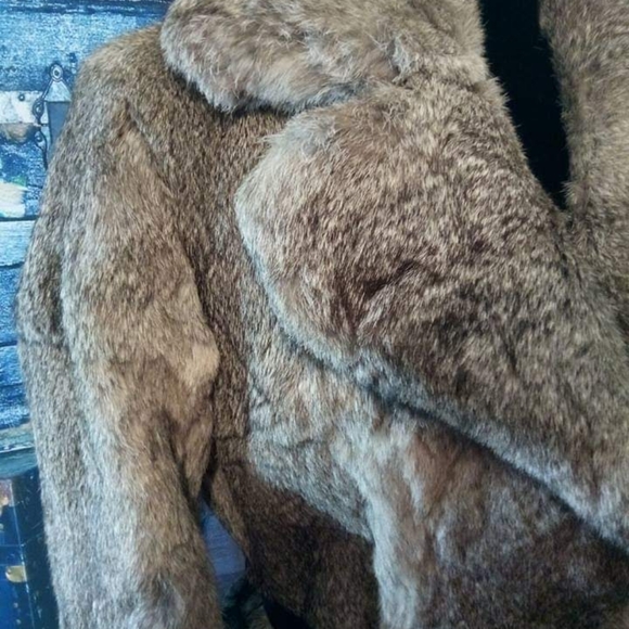 Vintage fur coat with leather waist belt.